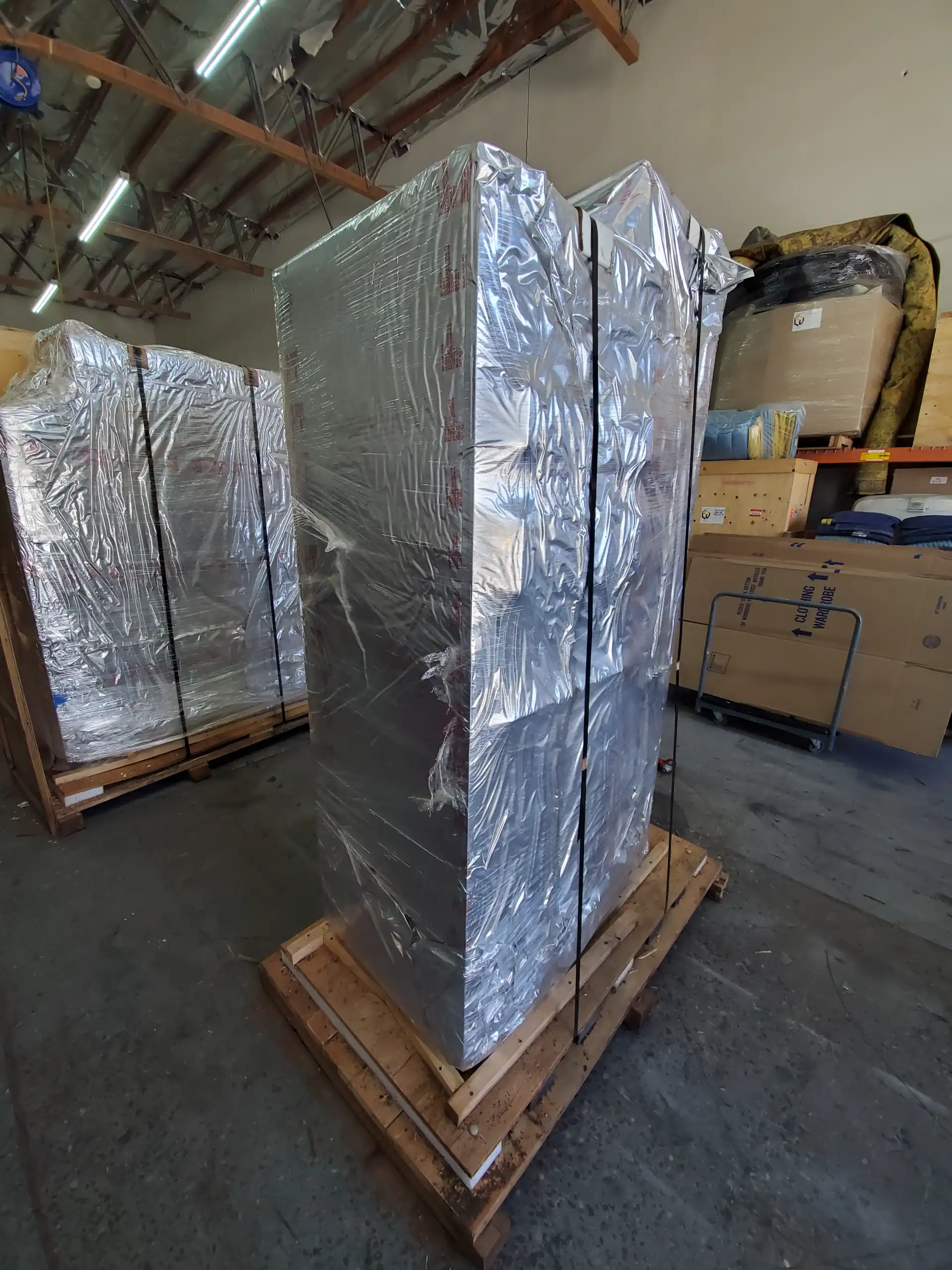 Large item wrapped in vapor barrier foil on a pallet